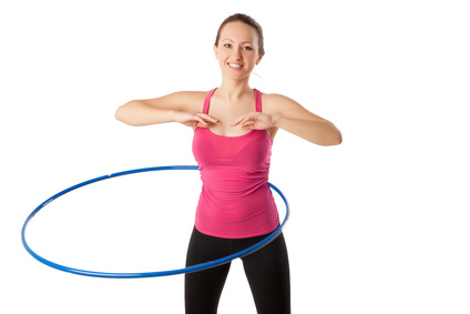 Fitness woman working with hula hoop smiling isolated over 